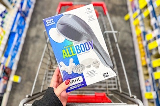 person holding a massager over a cart