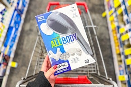 person holding a massager over a cart