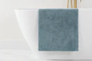 a grey bath mat on a bathtub 