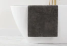 a grey bath mat on a bathtub 