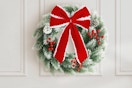 Pinkpum Lighted Christmas Wreath for Front Door Decor 16.5" hanging on a wall.