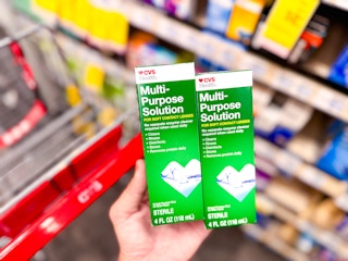 hand holding two boxes of contact solution