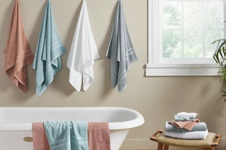 bath towels hanging on hooks in a bathroom