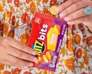 a person holding a snack bag of cracker sandwiches 