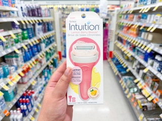 hand holding schick intuition razor in walgreens