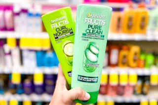 hand holding two garnier fructis products