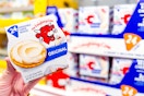 hand holding a pack of the laughing cow cheese wedges