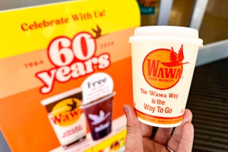 a sign at the wawa self serve coffee station advertising free hot coffee on Wawa Day