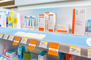 a shelf with bliss skincare products and clearance tags