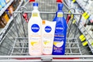 three nivea skin firming lotions in a shopping cart