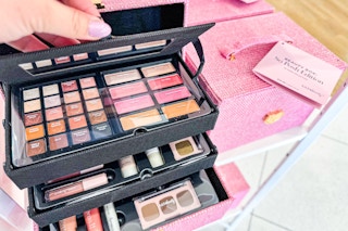 Ulta posh beauty box in store. Hand holding lid with all the makeup showing.
