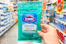 hand holding a pack of clorox wipes