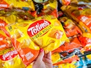 hand holding totinos pizza rolls at walmart