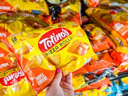 hand holding totinos pizza rolls at walmart