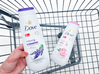 hand holding Dove body wash bottle