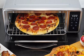 a pizza in the Kalorik Maxx Pizza Air Fryer Oven sitting on a kitchen counter