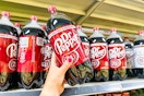 hand holding up a dr pepper 2-liter