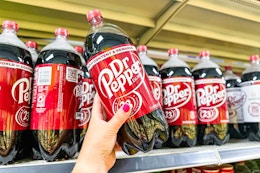 hand holding up a dr pepper 2-liter