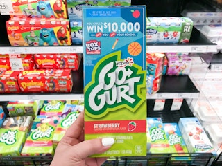 hand holding yoplait go-gurt yogurt tubes at target