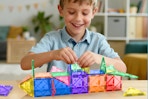 Boy playing with the Soyee Magnetic Tiles Toddler Toys Magnetic Building Blocks at a table.