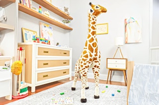 Lifestyle image of Melissa Doug Giraffe in child's bedroom setting