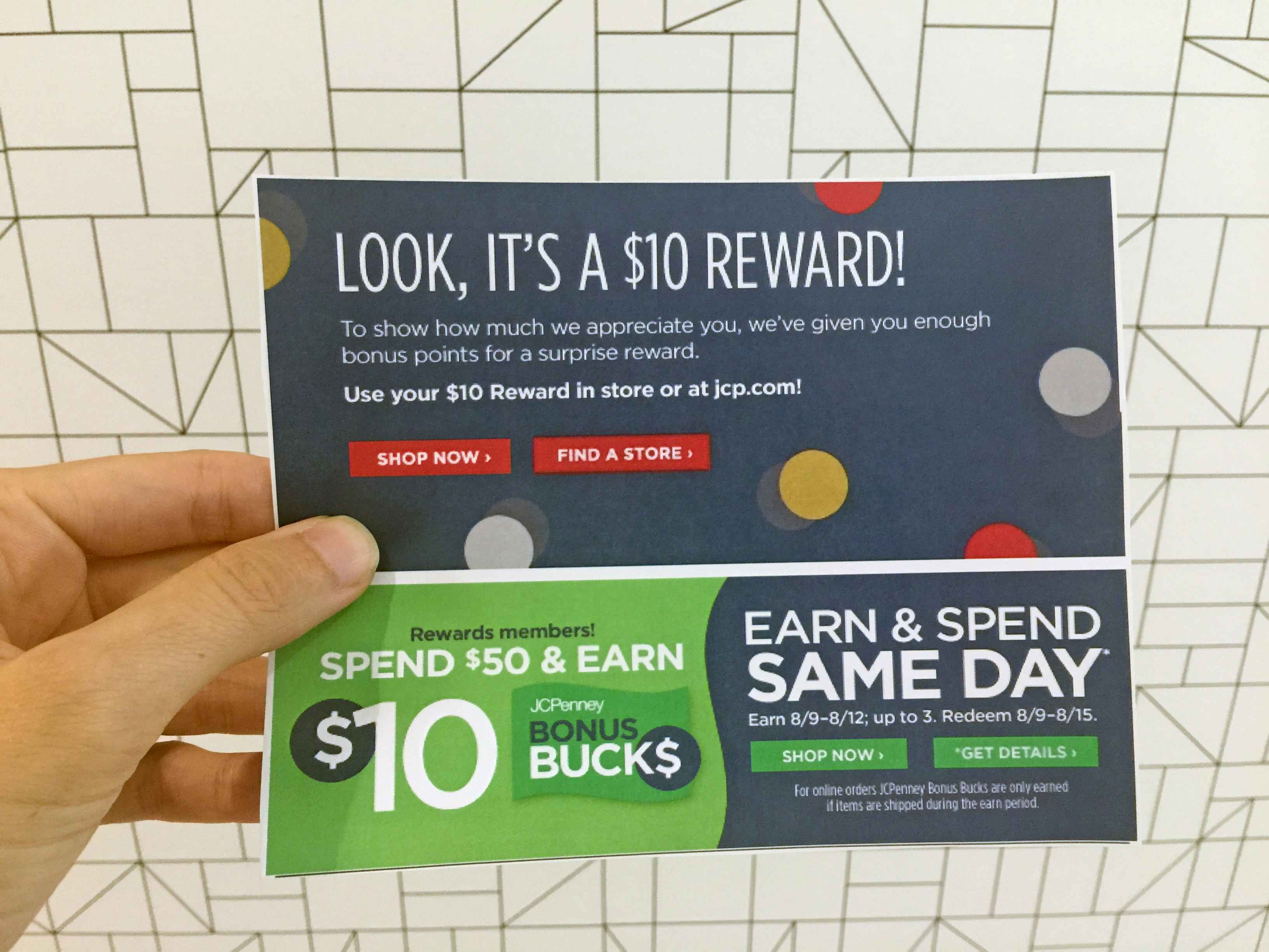 A person's hand holding a printed copy of a $10 Bonus Points reward for JCPenney.