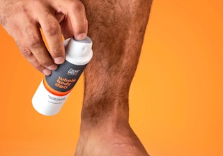 a person spraying whole body deodorant on their feet
