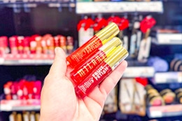 person holding 3 milani lip oils