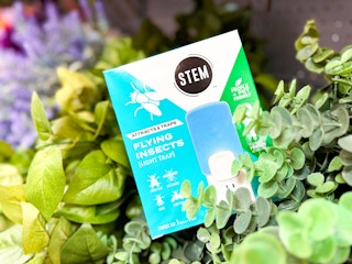 In-store image of a Stem Light Fly Trap at Walmart with foliage in the background