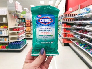 hand holding a package of clorox wipes at target