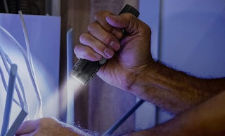 Person holding a flashlight