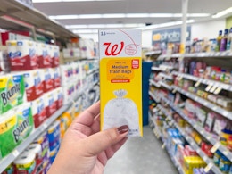 hand holding walgreens trash bags pack