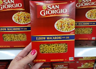 hand holding a box of san giorgio pasta at kroger