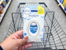 hand holding febreze bathroom air freshener in walgreens