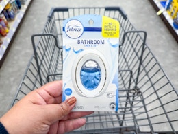 hand holding febreze bathroom air freshener in walgreens