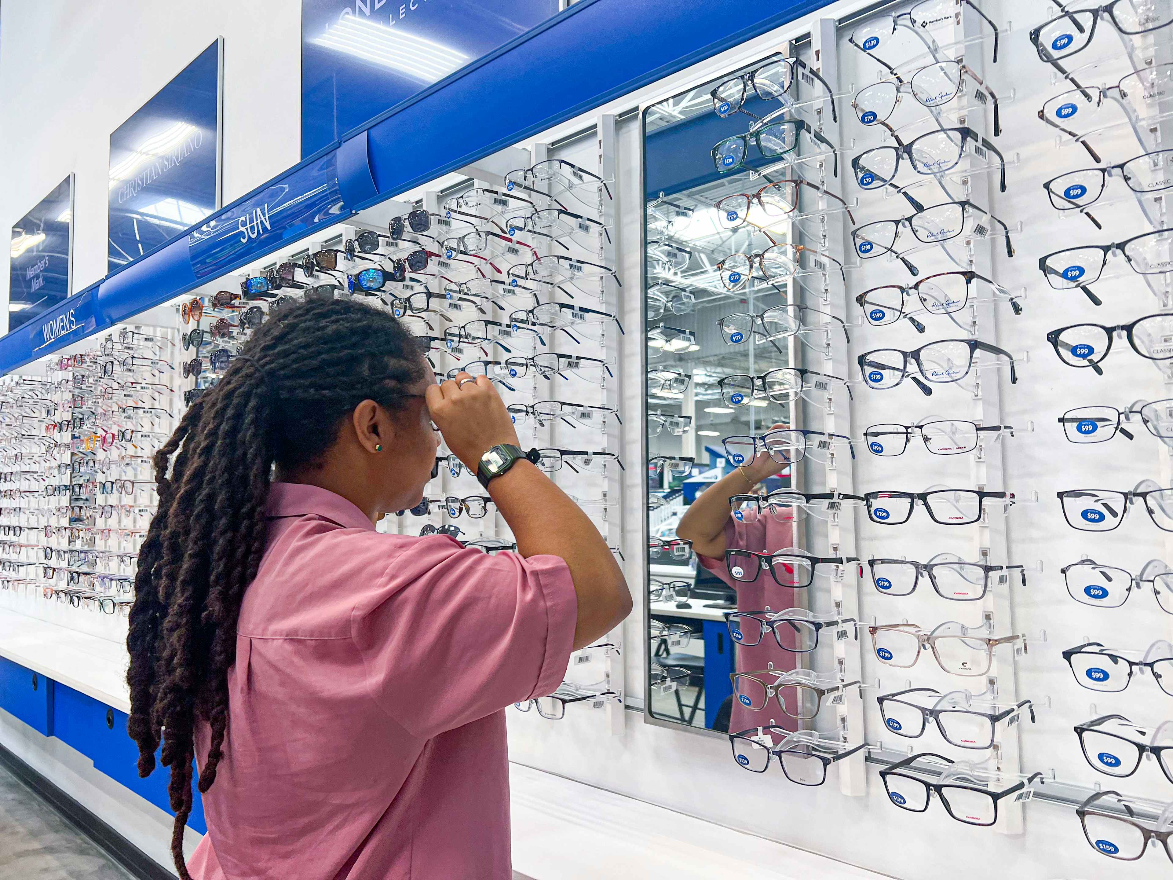 Person trying on eye frames at Sam's Club Optical