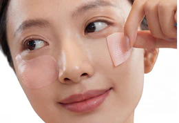 a person with pink eye patches under their eyes