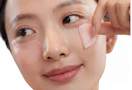 a person with pink eye patches under their eyes