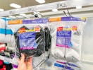 hand holding a pack of hanes women's socks in front of target shelves
