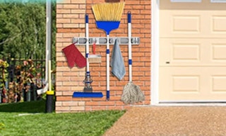 a wall mount holding brooms and tools
