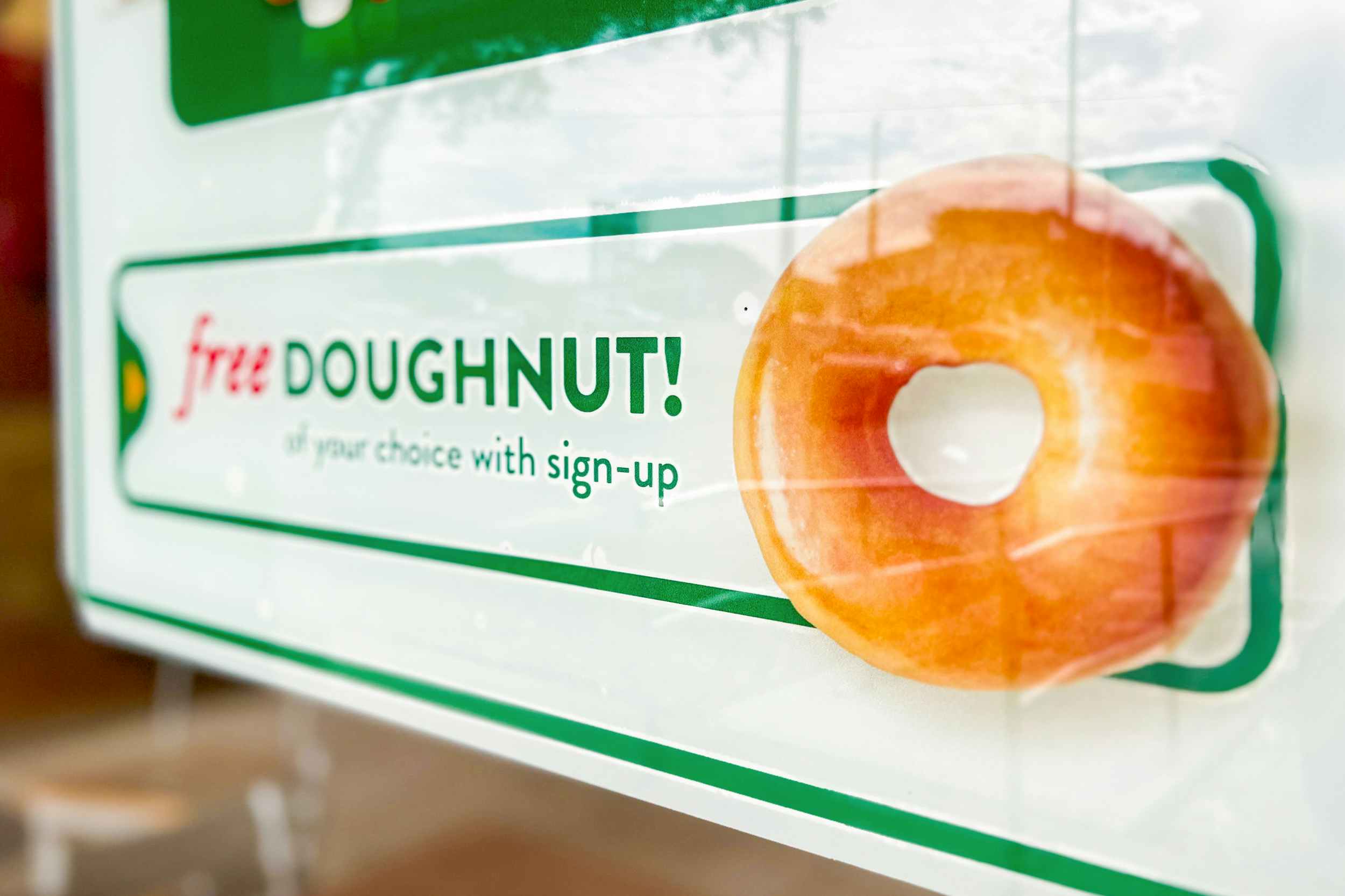a sign for a free donut at Krispy Kreme