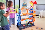 Lifestyle image of two kids playing with the Hot Wheels Ultimate Garage Playset from walmart.com