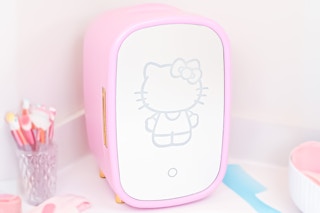 Lifestyle of Pink Hello Kitty Cosmetic Fridge (walmart.com) on bathroom counter