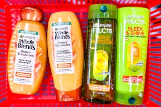garnier whole blends and fructis shampoo and conditioner in a red shopping basket