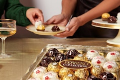 two people sharing ferrero rocher chocolates