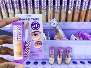 hand holding Tarte concealer