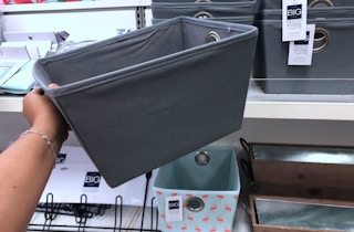 a hand holding up a big one storage bin