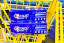 crest 3d white toothpastes stacked in yellow shopping cart