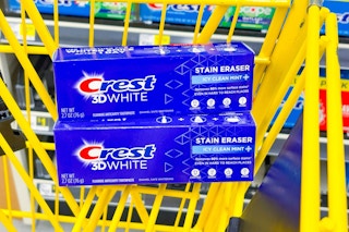 crest 3d white toothpastes stacked in yellow shopping cart