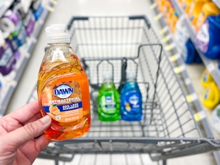 hand holding orange dawn dish soap in front of cart walgreens 1688317888 1688317888